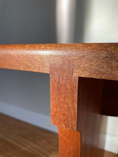 a close up of a wooden bench on a hard wood floor