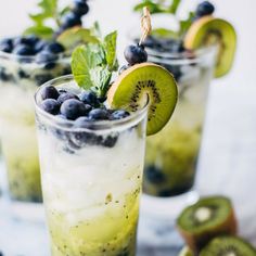 two glasses filled with blueberries and kiwi