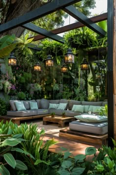 an outdoor living area with couches, tables and plants