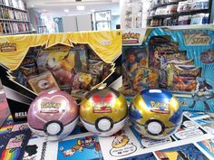 three pokemon ball toys are on display in a store