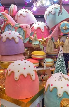 there are many colorful cakes on display in the store