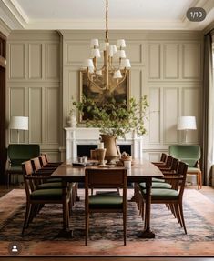 a dining room table with chairs and a vase on top of it in front of a fireplace