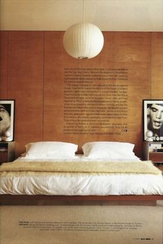 a large bed sitting in a bedroom next to a wooden wall