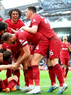 a group of men standing on top of a soccer field