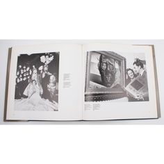 an open book with pictures of people and flowers on the pages, in black and white