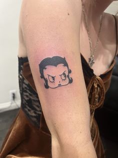 a woman's arm with a tattoo of a skull and a man's head