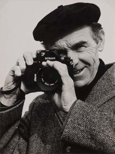 an old man taking a photo with a camera