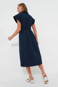 Elegant in its simplicity, the structured and ultra-ladylike Navy Chloe Dress is done in a textured cotton-blend fabric that is sure to turn heads for its design details. The moire pattern throughout and trapunto stitching on the sleeves, placket, and hemline complete this midi moment, making it feel extra special with minimal effort. Pair with heels or flats, sunnies or statement earrings, for day or night, and rest assured that you look fabulous! Spread collar Short wing sleeves Button front p Modern A-line Cotton Dress, Chic Cotton Dresses With Pleated Waist, Modern Fitted Cotton Dresses, Chic Cotton Dress With Pleated Waist, Elegant Cotton Dress With Pleated Waist, Chic Cotton Maxi Shirt Dress, Knee-length Cotton Dress With Pleated Waist, Modern Cotton Midi Dress, Cotton Knee-length Dress With Pleated Waist