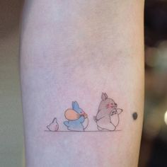 a small tattoo on the leg of a person with an animal and bird in it