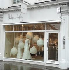 a store front with mannequins in the window