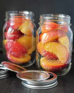 two mason jars filled with sliced peaches and oranges