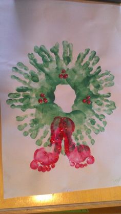 a painting with green and red hand prints on it