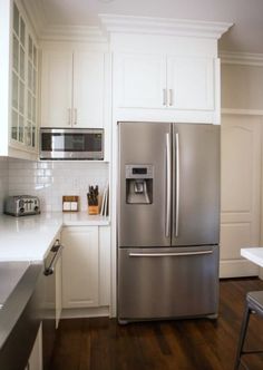 a silver refrigerator freezer sitting inside of a kitchen