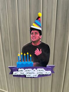 a man wearing a birthday hat with candles on it