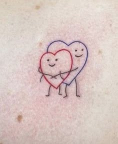 two hearts hugging each other on the back of a woman's stomach, with one heart in the middle