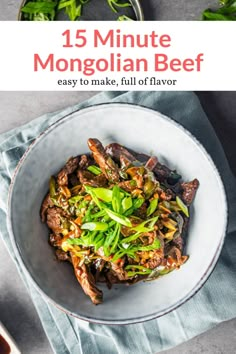 a white bowl filled with beef and vegetables on top of a blue napkin next to a fork