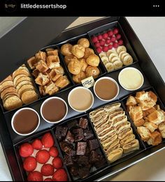 a tray filled with lots of different types of pastries and desserts on top of a table