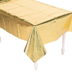 a table covered in gold cloths with white legs