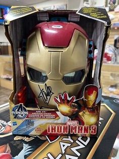 an iron man helmet is on display at a toy store with other items in the background