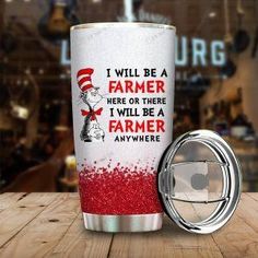 the cat in the hat tumbler is next to a can opener on a wooden table