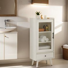 a bathroom with a white cabinet and sink