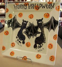 a plate decorated with bats and pumpkins for halloween