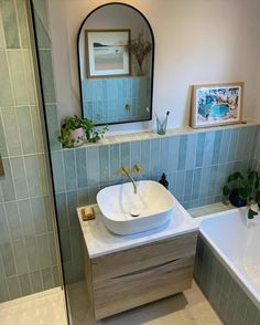 a bathroom with a sink, mirror and bathtub