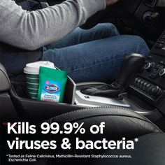 a man driving a car with the caption kills 99 % of viruses & bacter