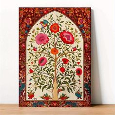 an intricately decorated tree with red flowers and leaves on the bottom, in front of a white wall