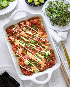 a casserole dish filled with vegetables and sauce