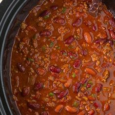 a crock pot filled with chili and beans