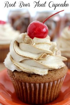 there is a cupcake with cream frosting and a cherry on top that says root beer float cupcake