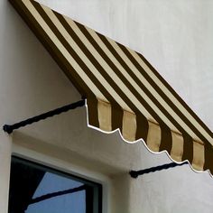 an awning on the side of a building with a window in front of it