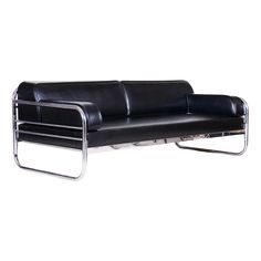 a black leather couch sitting on top of a metal frame