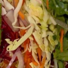 a salad with lettuce, carrots and other vegetables