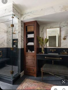 a bathroom with marble walls and flooring, black countertop, gold trimming