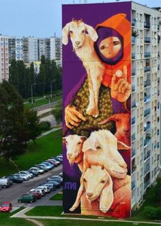 a large mural on the side of a building with animals painted on it's sides