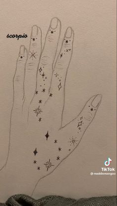 a hand with stars drawn on it and the words scorpion written in black ink above it