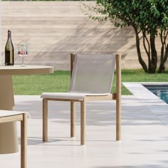 two chairs and a table near a pool