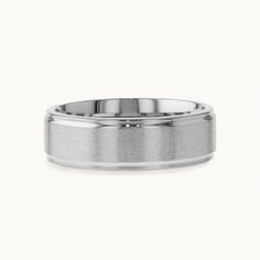 a white gold wedding ring with a flat surface and polished finish on the inside of it