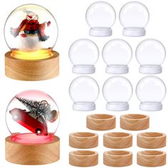 snow globe with wooden base and 12 clear glass balls in front of it, all on top of each other