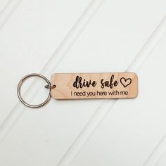 a wooden keychain that says, drive safe i need you here with me