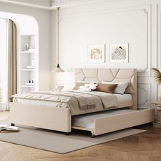 a bedroom with white walls and wood flooring has a large bed in the middle