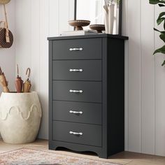 a black chest of drawers in a room