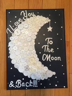 a black and white sign with buttons on it that says i love you to the moon and back