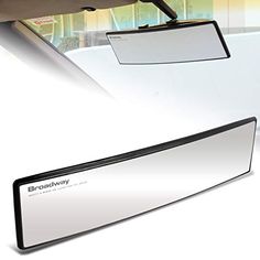 the rear view mirror is mounted to the side of a car's roof window