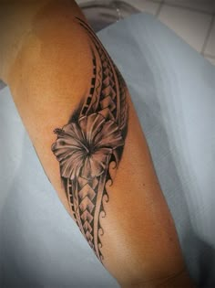 a woman's arm with a butterfly and braids tattoo design on the arm