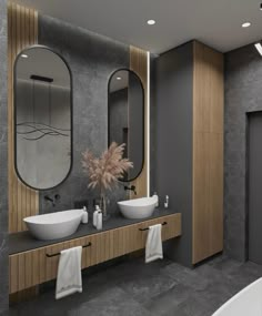 a modern bathroom with two sinks and mirrors