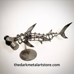 a metal fish sculpture on top of a table