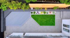 an overhead view of a backyard with green grass and plants on the roof, as seen from above